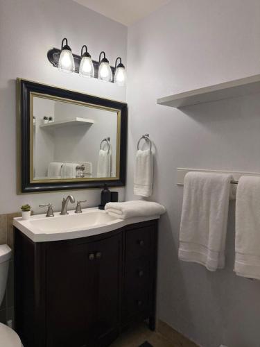 a bathroom with a sink and a mirror and towels at Lovely Provo Oasis in Provo
