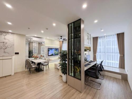 an office with a dining room and a kitchen with a table at TC1 Canopy Luxhome Smart City in Phú Thú