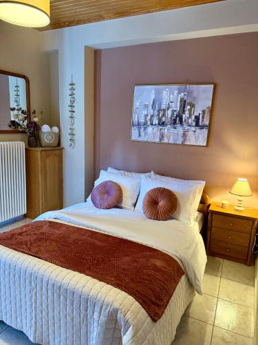 a bedroom with a bed with two pillows on it at Arcadian Escape - Tsiaxtai Group in Lagadia