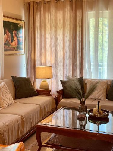 a living room with a couch and a coffee table at Arcadian Escape - Tsiaxtai Group in Lagadia