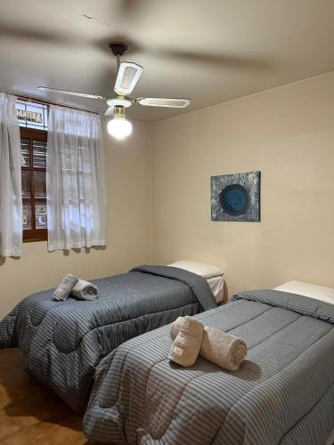a bedroom with two beds and a ceiling at Casona Liniers in Godoy Cruz