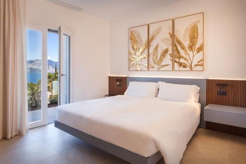 a bedroom with a large bed and a large window at Villa aMA with Pool in Pai