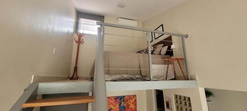 a spiral staircase in a room with a window at Casa Loft 9C in São Luís