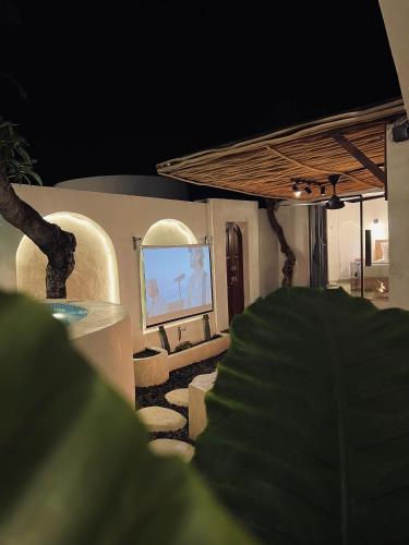 a living room with a tv and a stage at Batur Cozy Bali in Kintamani