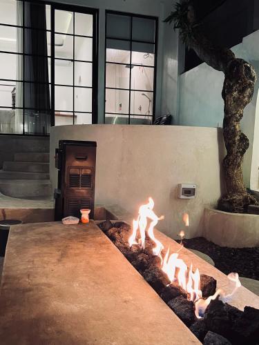 a fire pit with a person in front of it at Batur Cozy Bali in Kintamani