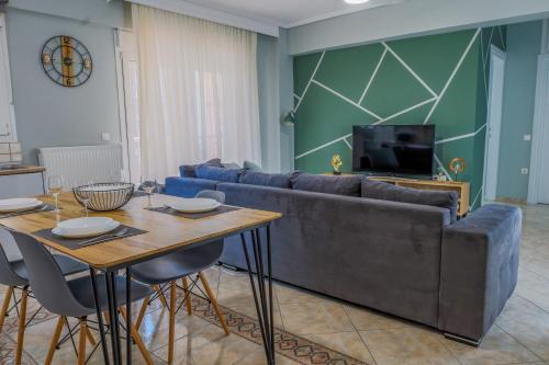 a living room with a couch and a table at The perfect apartment 2 in Thessaloniki