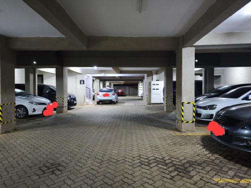a parking garage with cars parked in it at Platinum Place in Kikuyu