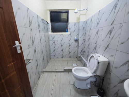 a bathroom with a toilet and a window at Platinum Place in Kikuyu