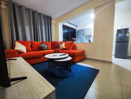 a living room with a red couch and a table at Platinum Place in Kikuyu