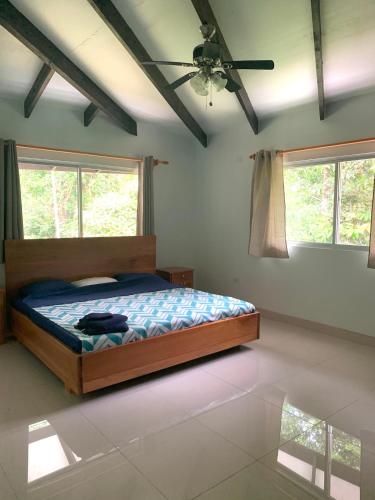 a bedroom with a bed and a ceiling fan at Dominical Beach 15 min Private Retreat Casa Grande in Platanillo