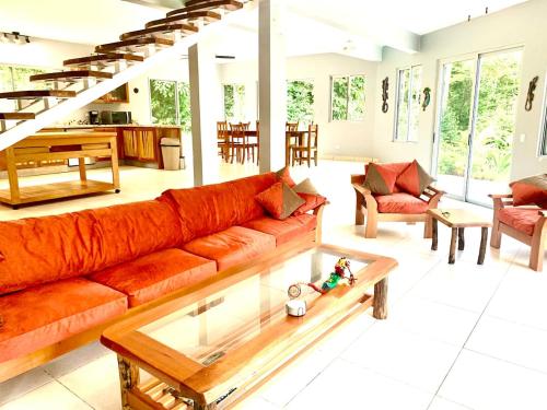 a living room with a couch and a coffee table at Dominical Beach 15 min Private Retreat Casa Grande in Platanillo
