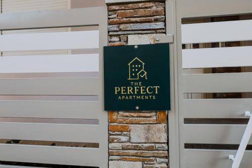 a sign for the perfect apartment sign on a wall at The perfect apartment 2 in Thessaloniki