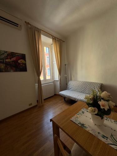 a living room with a table and a couch at Cozy Escape Porta Romana in Milan