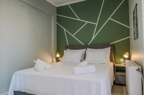 a bedroom with a white bed with two white towels at The perfect apartment 2 in Thessaloniki