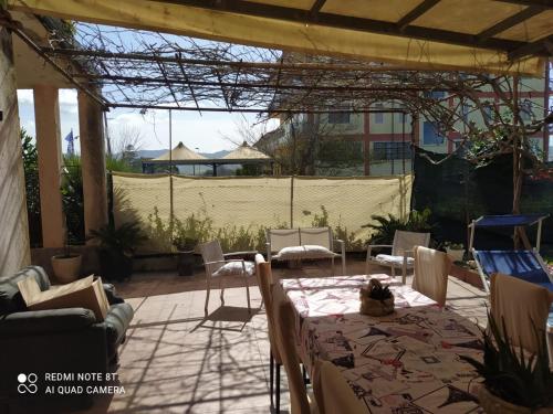 a patio with a table and chairs at PM 698 Via Fuscillo in Mattine
