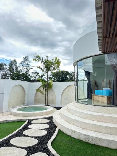 a house with a glass house with a garden at Batur Cozy Bali in Kintamani