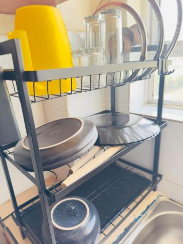 a shelf in a kitchen with pots and pans at The LuxeLoft in Eldoret