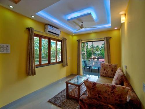 a living room with a couch and a table at Villa platinum 4 BHK Calangute in Calangute