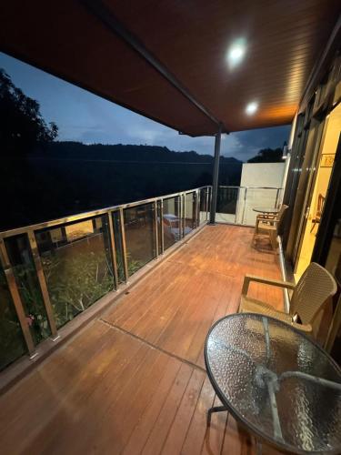 a deck with a table and chairs on a balcony at Villa Munjul Indah - Majalengka in Jatipamor