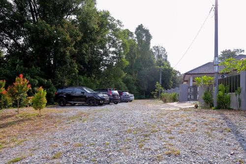 a row of parked cars parked in a driveway at Anjung Homestay & Event in Bukit Payong