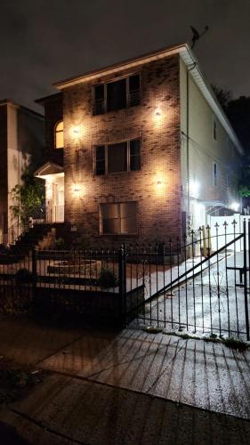 a building with a fence in front of it at night at Classic Comfort Inn in Newark