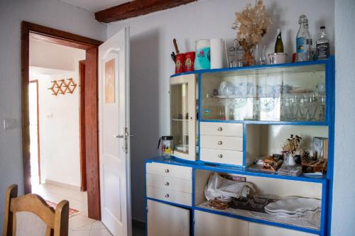 a blue shelf in a room with a dresser at Malo selo Kurikuce in Berane