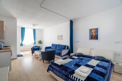 a bedroom with a bed and a living room at Apartamentai pas Reginą in Palanga