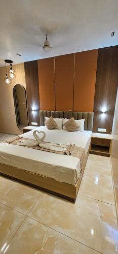 a bedroom with two beds in a room at Hotel Vaishno Regal in Bhubaneshwar