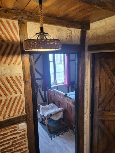 a room with a bedroom with a bed and a mirror at Maison Médiévale LAON in Laon