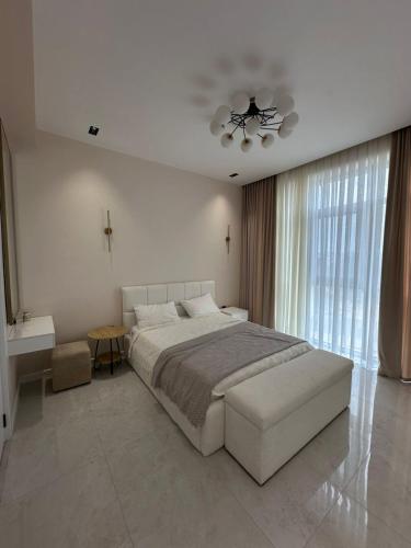 a bedroom with a large bed and a ceiling fan at Квартира в SEEBREZE in Nardaran