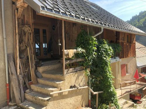 a house with stairs leading to the front door at chalet de l'eau rousse in La Lechere