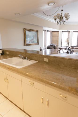 a kitchen with a sink and a counter top at Historic Santa Maria Inn in Santa Maria