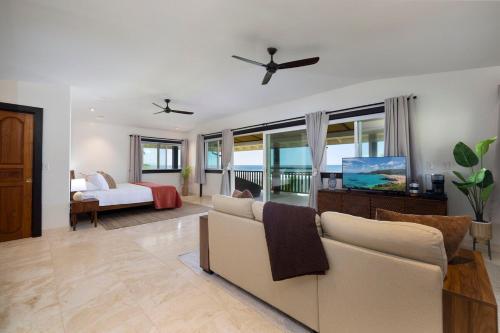 a living room with a couch and a bed at Hale Holawa Mana-Oceanfront Sunset Beach in Haleiwa
