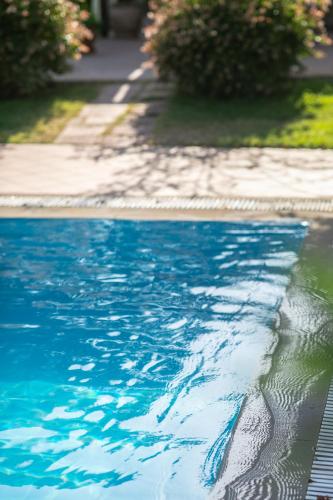 a swimming pool with blue water in a yard at Electra Hotel in Stavros