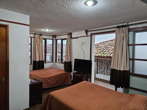 Postel nebo postele na pokoji v ubytování Posada Brisas Cuetzalan