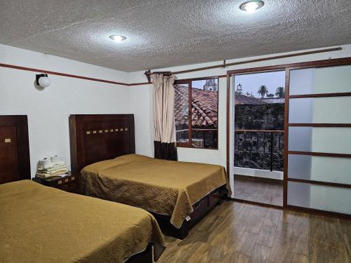 Postel nebo postele na pokoji v ubytování Posada Brisas Cuetzalan