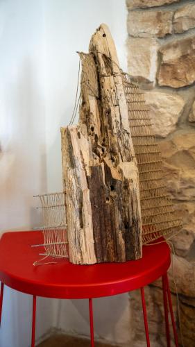 a piece of wood sitting on top of a red table at Apartman Genio in Žminj