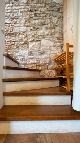 a stone wall and stairs in a room at Apartman Genio in Žminj