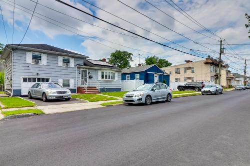 a group of cars parked on a street with houses at 5 Mi to Dtwn Newark Hillside Vacation Rental in Hillside