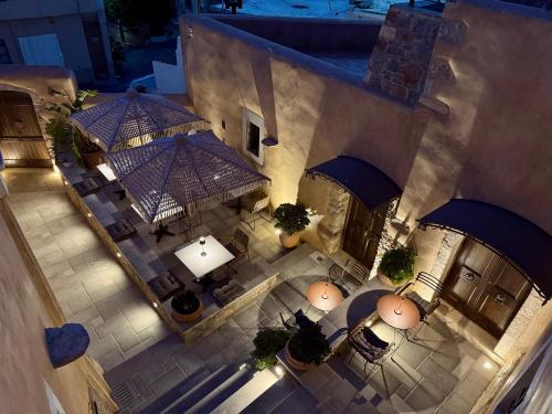 an overhead view of a building with tables and umbrellas at Santa Veneranda Suites "by Checkin" in Ayía Paraskeví