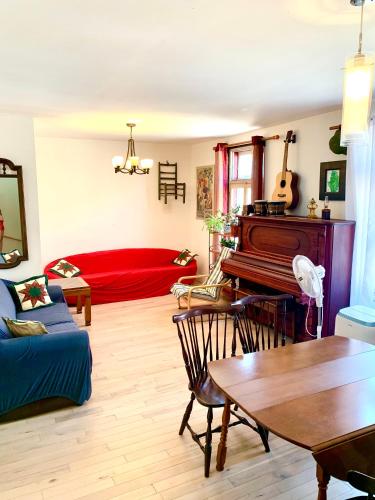 a living room with a piano and a couch at 6 people, big, free parkings, near Old Quebec, near river in Quebec City