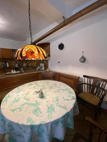 a kitchen with a table and a stained glass window at PM 25 Via Trepene in Castellonorato