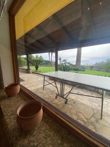a table in a room with a large window at PM 25 Via Trepene in Castellonorato