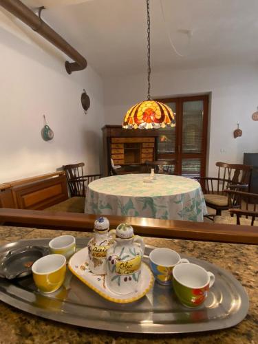 a tray with bowls and cups on a table at PM 25 Via Trepene in Castellonorato