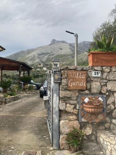 a stone building with a sign on the side of a road at PM 25 Via Trepene in Castellonorato