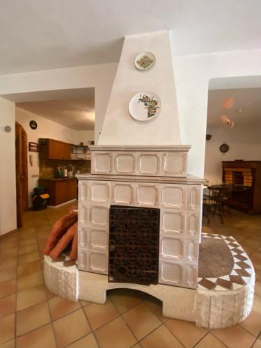 a white fireplace with a plate on top of it at PM 25 Via Trepene in Castellonorato