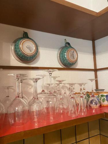 a bunch of wine glasses sitting on a shelf at PM 25 Via Trepene in Castellonorato
