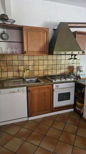 a kitchen with a stove and a sink at PM 25 Via Trepene in Castellonorato