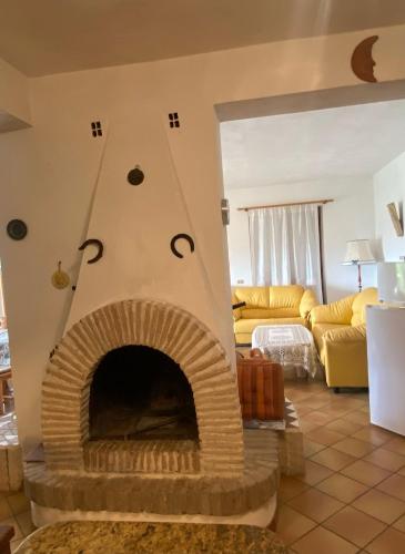 a living room with a brick fireplace in a living room at PM 25 Via Trepene in Castellonorato