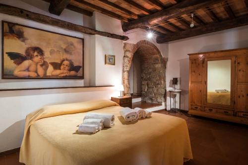 a bedroom with a bed with towels on it at Querceto Di Castellina in Castellina in Chianti